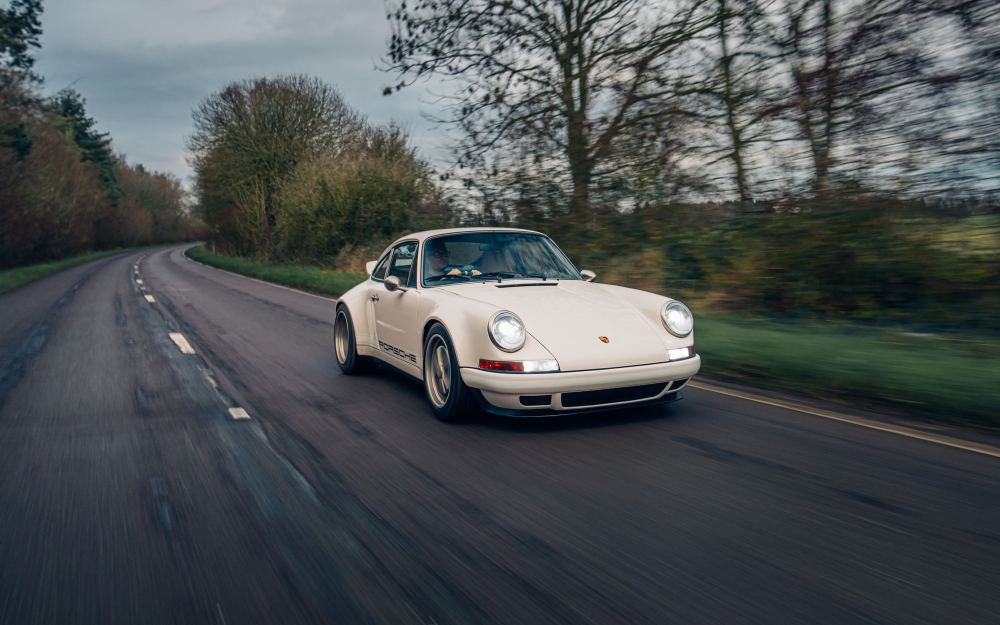 Cream Coupé, a Porsche 911 (964) reimagined by Theon Design: driving along a tree-lined country road