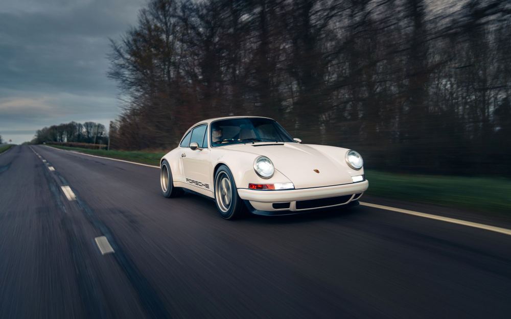 Cream Coupé, a Porsche 911 (964) reimagined by Theon Design: front view on a country road under a cloudy sky