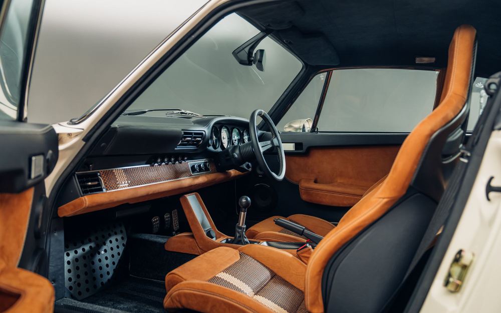 Cream Coupé, a Porsche 911 (964) reimagined by Theon Design: tan leather seats and dashboard seen through the open door