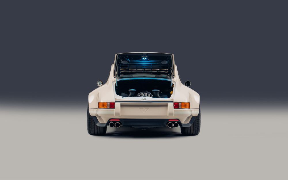 Cream Coupé, a Porsche 911 (964) reimagined by Theon Design: rear view with the engine lid open against a dark backdrop