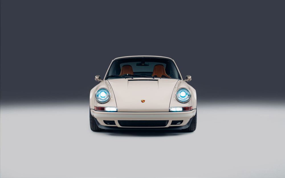 Cream Coupé, a Porsche 911 (964) reimagined by Theon Design: front view with headlights on in the studio