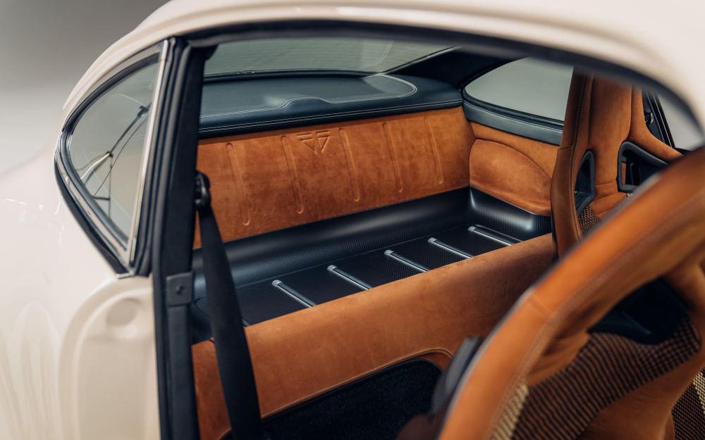 Cream Coupé, a Porsche 911 (964) reimagined by Theon Design: tan leather rear luggage shelf seen through the open door