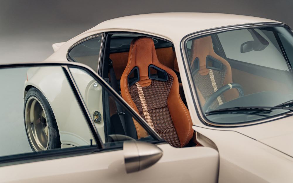 Cream Coupé, a Porsche 911 (964) reimagined by Theon Design: tan leather seats seen through the open passenger door