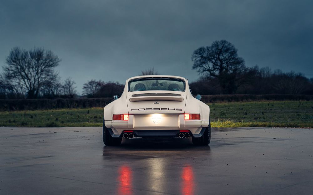 Cream Coupé, a Porsche 911 (964) reimagined by Theon Design: rear view with tail lights on, on wet tarmac