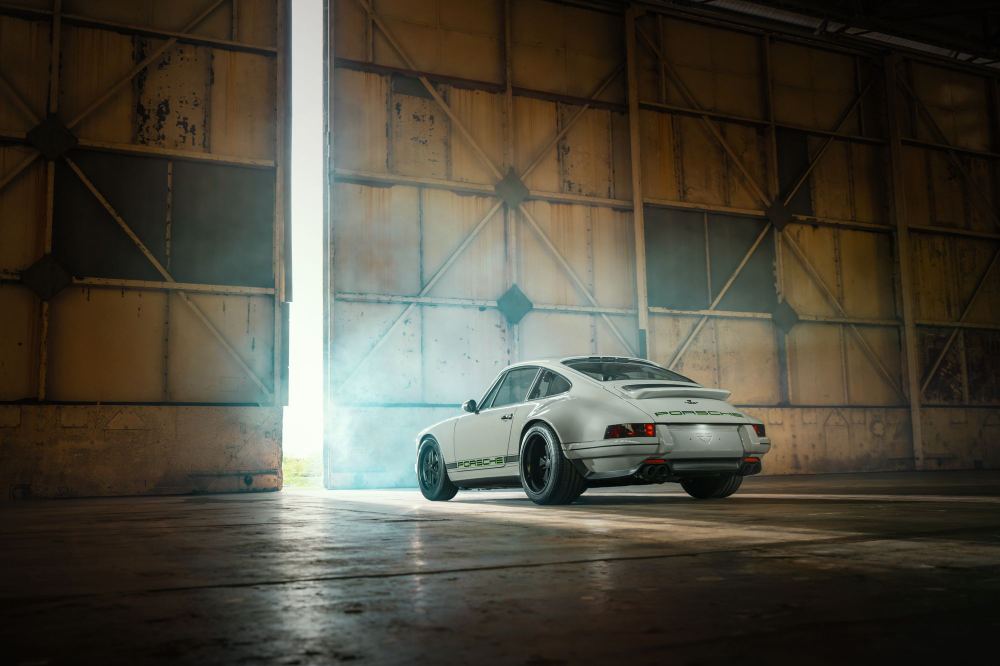 Silver Coupé, a Porsche 911 (964) reimagined by Theon Design: rear three-quarter view in a hangar