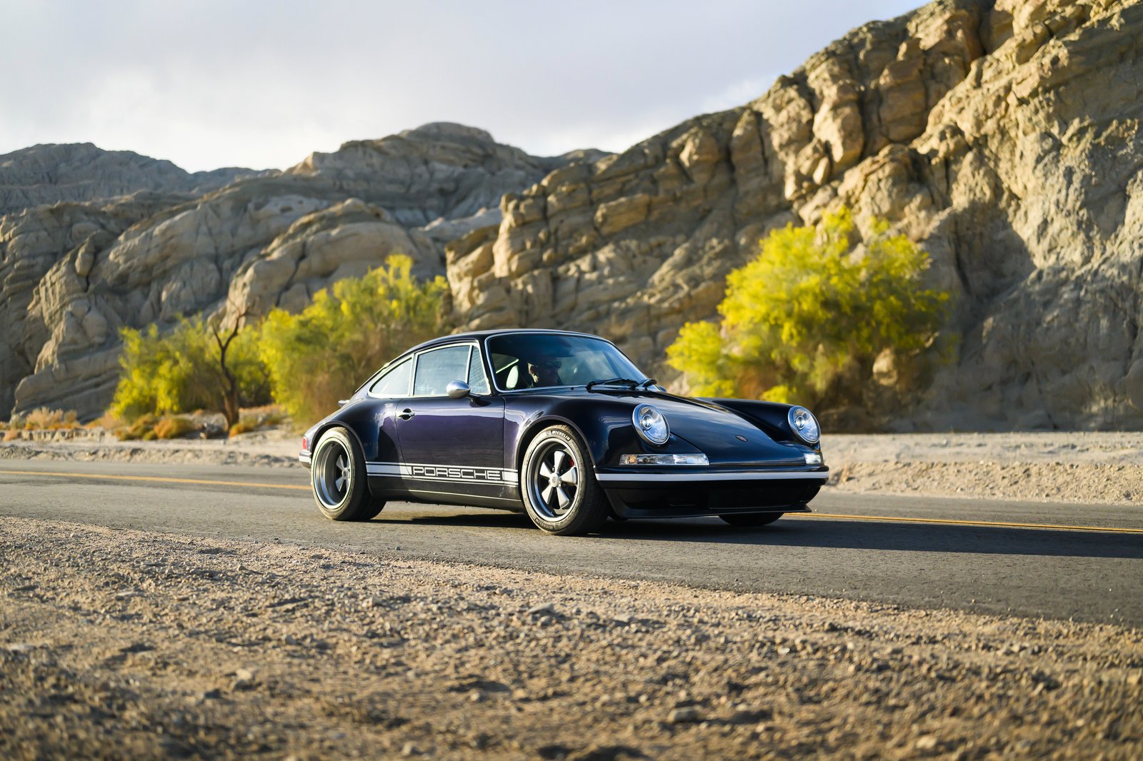 Theon Design Porsche 964 restomod in midnight blue on Joshua Tree desert road California